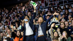 family members wave to their students at Commencement 2023