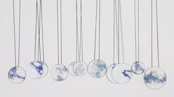 a series of pendants portraying images of the sky