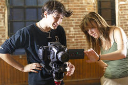 two students work with a video camera