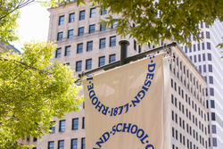 RISD flags flying in front of downtown highrises