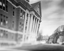 A black and white, skewed looking photo of the front of hope high school by Ethan Brossard