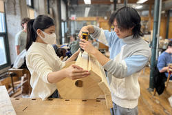 Industrial design students skylar and tess design working in the woodshop while designing an enrichment object for snow leopards