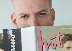 Alum Mel Ottenberg looks over a copy of Interview magazine.