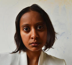 Photo of alumni Tara Gupta in a white suit jacket.