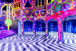 A blacklit immersive art fun house type room.