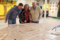 community members study an installation created by Viola Tan