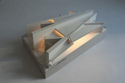 Student work by Architecture graduate alum Oliver Jacob of an angular model structure that is lit from the inside.