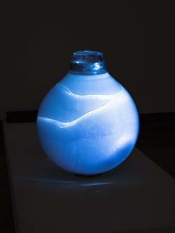 a vibrant blue-and-white orb glows against a black backdrop