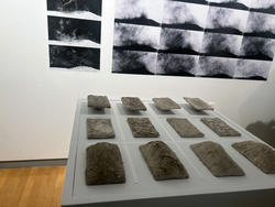 image of clay samples on a grid on a table with photography behind it