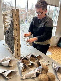student working on a large brick structure