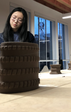 student working on clay