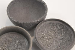 three gray bowls made of organic matter nestled together