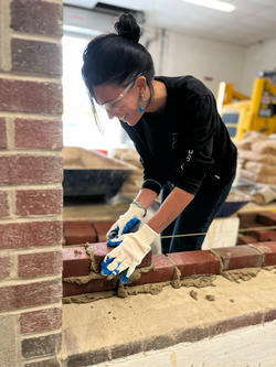 a student engaged in masonry work
