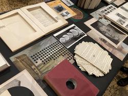 Student work by Graphic Design graduate alum Rebecca Wilkinson of a literature display with books and pages splayed in various formats.