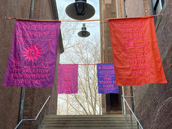 Student work by Graphic Design graduate alum Zoë Pulley of bright banners with political statements.