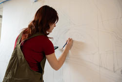 Student sketches out a mural