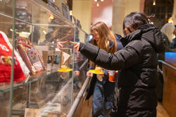Students observe artists' books in cases