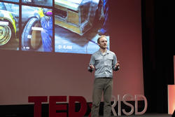 Presenter Gresh Chapman gives a speech on stage