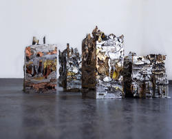 A collection of rectangular pillar metalworks composed of different metals and metallic objects
