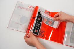 Student work by graphic design student Nada Rodanant of someone flipping through and orange and clear booklet.